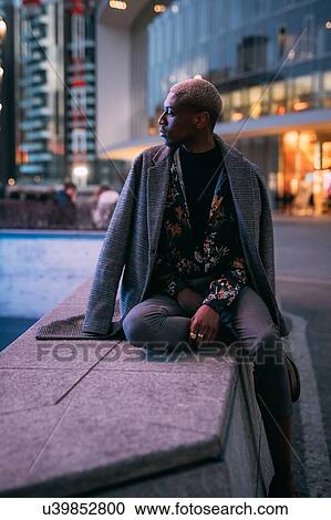 Stylish man sitting on concrete bench, Milan, Italy View Large Photo Image Stock Image - Stylish man sitting on concrete bench, Milan, Italy. Fotosearch
