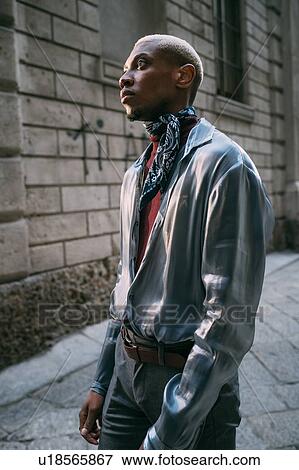 Stock Photo - Stylish man standing by period building, Milan, Italy. Fotosearch