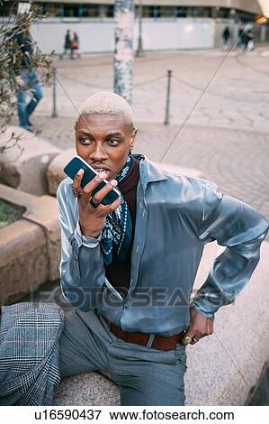 Stylish man using cellphone in piazza, Milan, Italy View Large Photo Image Stock Photo - Stylish man using cellphone in piazza, Milan, Italy. Fotosearch
