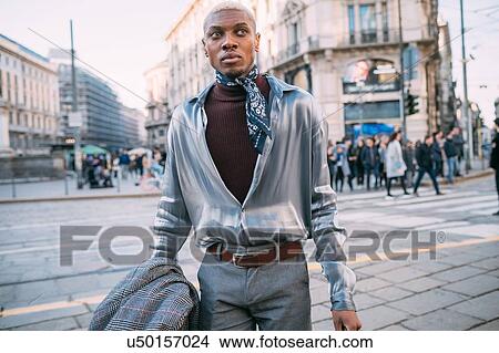 Picture - Stylish man walking in street, Milan, Italy. Fotosearch