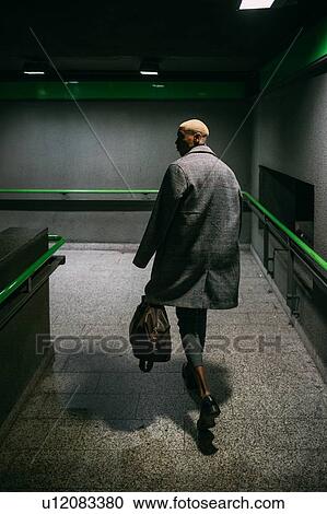 Stock Image - Stylish man walking in subway, Milan, Italy. Fotosearch