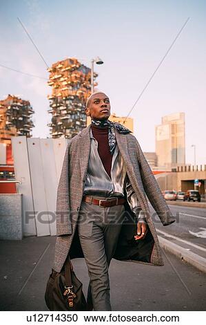Stock Image - Stylish man walking on street, Milan, Italy. Fotosearch