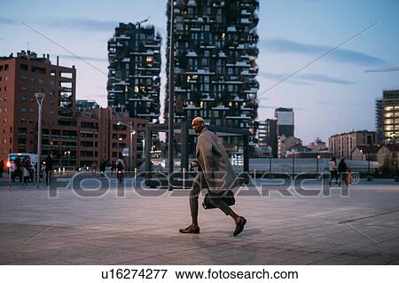 Stylish man walking through piazza, Milan, Italy View Large Photo Image Stock Photo - Stylish man walking through piazza, Milan, Italy. Fotosearch
