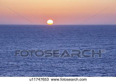 Sunset at sea View Large Photo Image Stock Image - Sunset at sea. Fotosearch
