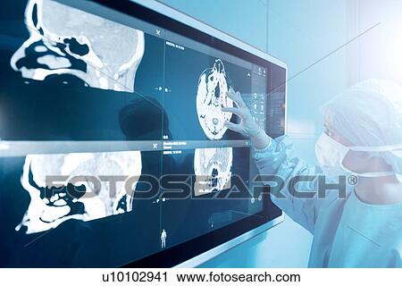 Surgeon looking at MRI scans View Large Photo Image Stock Image - Surgeon looking at MRI scans. Fotosearch