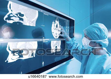 Surgeon looking at MRI scans View Large Photo Image Stock Photo - Surgeon looking at MRI scans. Fotosearch
