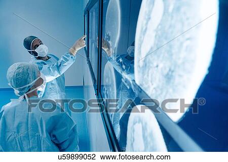 Surgeons looking at MRI scans during surgery View Large Photo Image Stock Image - Surgeons looking at MRI scans during surgery. Fotosearch