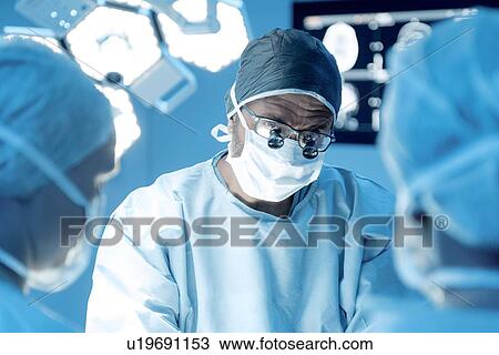 Surgical team in operating theatre View Large Photo Image Stock Image - Surgical team in operating theatre. Fotosearch