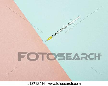 Stock Photograph - Syringe piercing skin, conceptual image. Fotosearch
