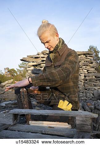 Teenage boy prepares wood for campfire in forest, Fr, Gotlands Lan, Sweden View Large Photo Image Picture - Teenage boy prepares wood for campfire in forest, Fr, Gotlands Lan, Sweden. Fotosearch
