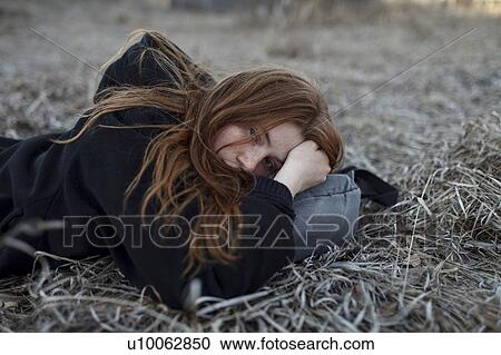 Teenage girl lying on bag in field View Large Photo Image Stock Image - Teenage girl lying on bag in field. Fotosearch