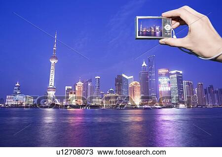 Stock Image - Tourist photographing Shanghai skyline, China. Fotosearch