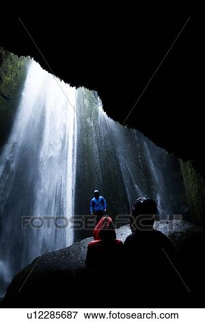 Tourists below overhanging rock in front of waterfall, Selfoss, Arnessysla, Iceland View Large Photo Image Stock Photo - Tourists below overhanging rock in front of waterfall, Selfoss, Arnessysla, Iceland. Fotosearch