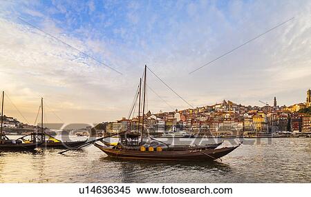 Traditional Portuguese wooden cargo boats transporting port wine on Douro River, Porto, Portugal View Large Photo Image Stock Photography - Traditional Portuguese wooden cargo boats transporting port wine on Douro River, Porto, Portugal. Fotosearch