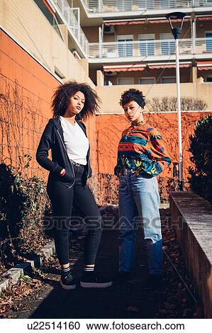 Two cool young female friends in urban garden, portrait View Large Photo Image Stock Image - Two cool young female friends in urban garden, portrait. Fotosearch