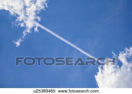 Vapor trail between clouds View Large Photo Image Stock Photography - Vapor trail between clouds. Fotosearch