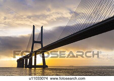 Vasco da Gama Bridge spanning Tagus river at sunset, Portugal View Large Photo Image Picture - Vasco da Gama Bridge spanning Tagus river at sunset, Portugal. Fotosearch