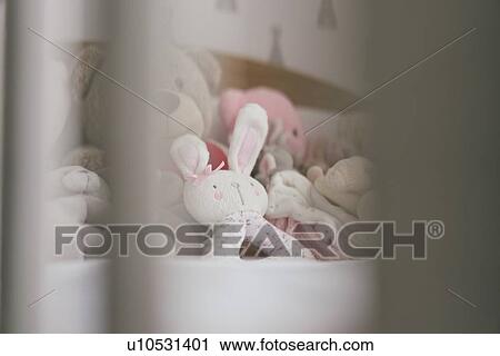 View of soft toys on bed through crib slats View Large Photo Image Stock Image - View of soft toys on bed through crib slats. Fotosearch