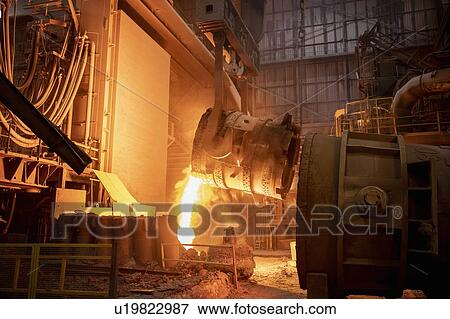 Stock Photo - Waste steel pouring away from flask in steelworks. Fotosearch