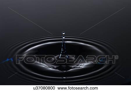 Stock Image - Water drop creating circular ripples. Fotosearch