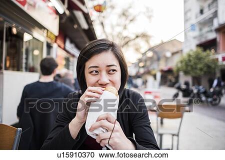 Stock Image - Woman eating kebab bread at cafe, Kusadasi, Izmir, Turkey. Fotosearch
