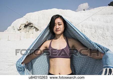 Stock Image - Woman enjoying cotton castle, Pamukkale, Denizli, Turkey. Fotosearch