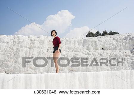 Stock Photograph - Woman enjoying cotton castle, Pamukkale, Denizli, Turkey. Fotosearch