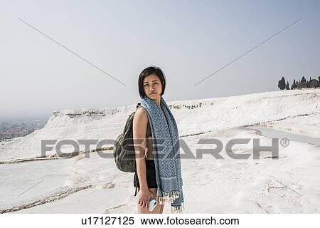 Stock Photography - Woman enjoying cotton castle, Pamukkale, Denizli, Turkey. Fotosearch