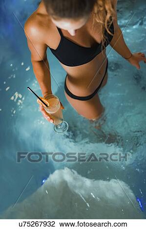 Stock Image - Woman enjoying hot tub in a spa. Fotosearch
