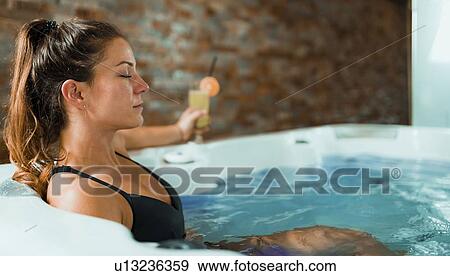 Woman enjoying hot tub in a spa View Large Photo Image Stock Photo - Woman enjoying hot tub in a spa. Fotosearch