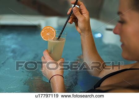 Stock Photo - Woman enjoying hot tub in a spa. Fotosearch