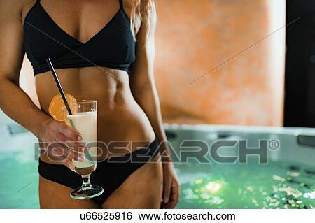 Stock Photograph - Woman enjoying hot tub in a spa. Fotosearch
