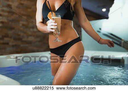 Stock Photography - Woman enjoying hot tub in a spa. Fotosearch