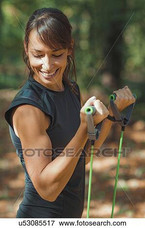 Woman exercising in the park View Large Photo Image Stock Photo - Woman exercising in the park. Fotosearch