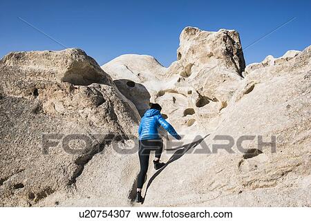 Stock Photo - Woman exploring rock formations, Greme, Cappadocia, Nevsehir, Turkey. Fotosearch