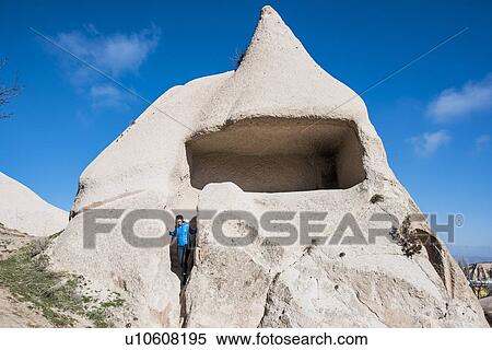 Stock Photography - Woman exploring Uchisar Castle, Greme, Cappadocia, Nevsehir, Turkey. Fotosearch