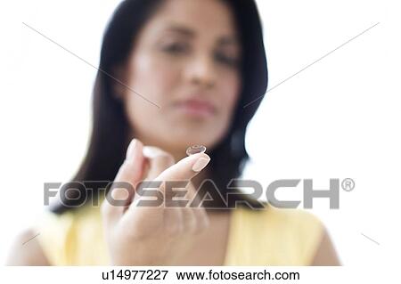 Woman holding contact lens View Large Photo Image Stock Photo - Woman holding contact lens. Fotosearch