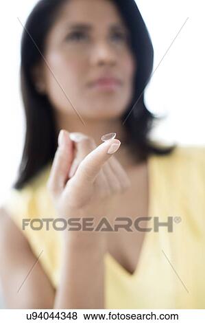 Woman holding contact lens View Large Photo Image Stock Photo - Woman holding contact lens. Fotosearch