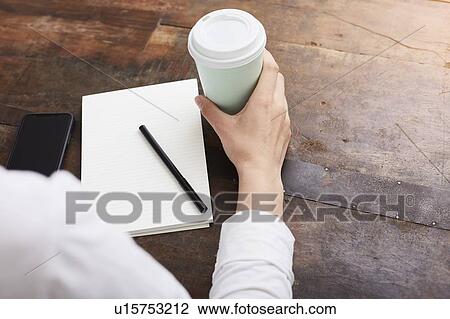 Stock Image - Woman in deep thought at coffee break. Fotosearch