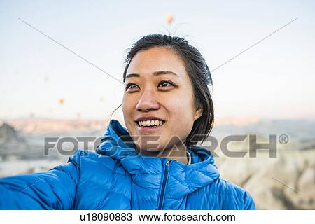 Stock Image - Woman looking into distance smiling, Greme, Cappadocia, Nevsehir, Turkey. Fotosearch
