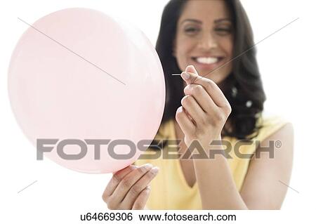Woman popping a balloon View Large Photo Image Stock Photograph - Woman popping a balloon. Fotosearch