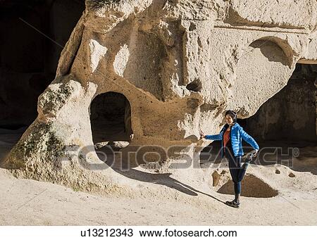 Stock Image - Woman practising yoga in Selime Monastery, Greme, Cappadocia, Nevsehir, Turkey. Fotosearch