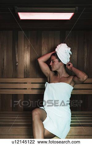 Woman relaxing in sauna View Large Photo Image Stock Image - Woman relaxing in sauna. Fotosearch