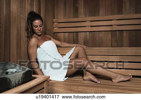 Woman relaxing in sauna View Large Photo Image Stock Photo - Woman relaxing in sauna. Fotosearch