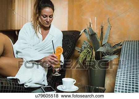 Stock Photo - Woman relaxing on a warm tepidarium bed. Fotosearch