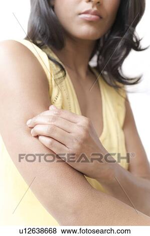 Woman scratching her arm View Large Photo Image Stock Photo - Woman scratching her arm. Fotosearch