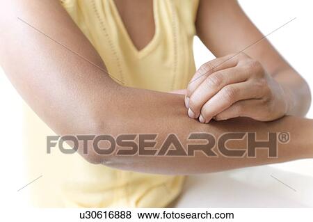 Stock Photo - Woman scratching her arm. Fotosearch
