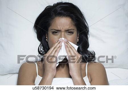 Woman sneezing in bed View Large Photo Image Picture - Woman sneezing in bed. Fotosearch