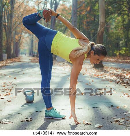 Woman stretching in the park View Large Photo Image Stock Photo - Woman stretching in the park. Fotosearch
