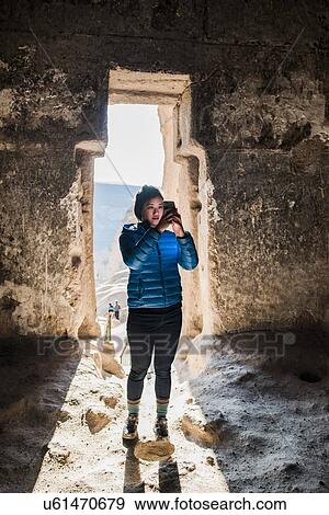 Stock Photo - Woman taking photograph in Selime Monastery, Greme, Cappadocia, Nevsehir, Turkey. Fotosearch